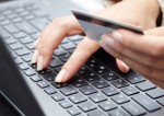woman holding credit card on laptop for online shopping concep
